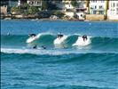 Three Surfers